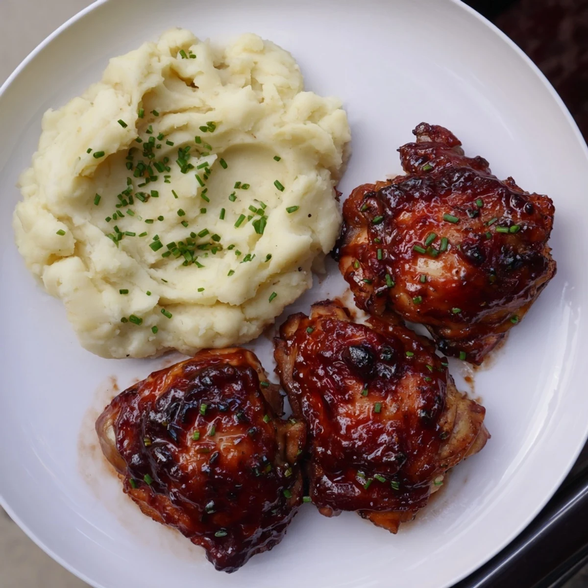 Tender Honey BBQ Chicken Thighs with a rich, savory aroma, paired with smooth, garlic-infused mashed potatoes. 