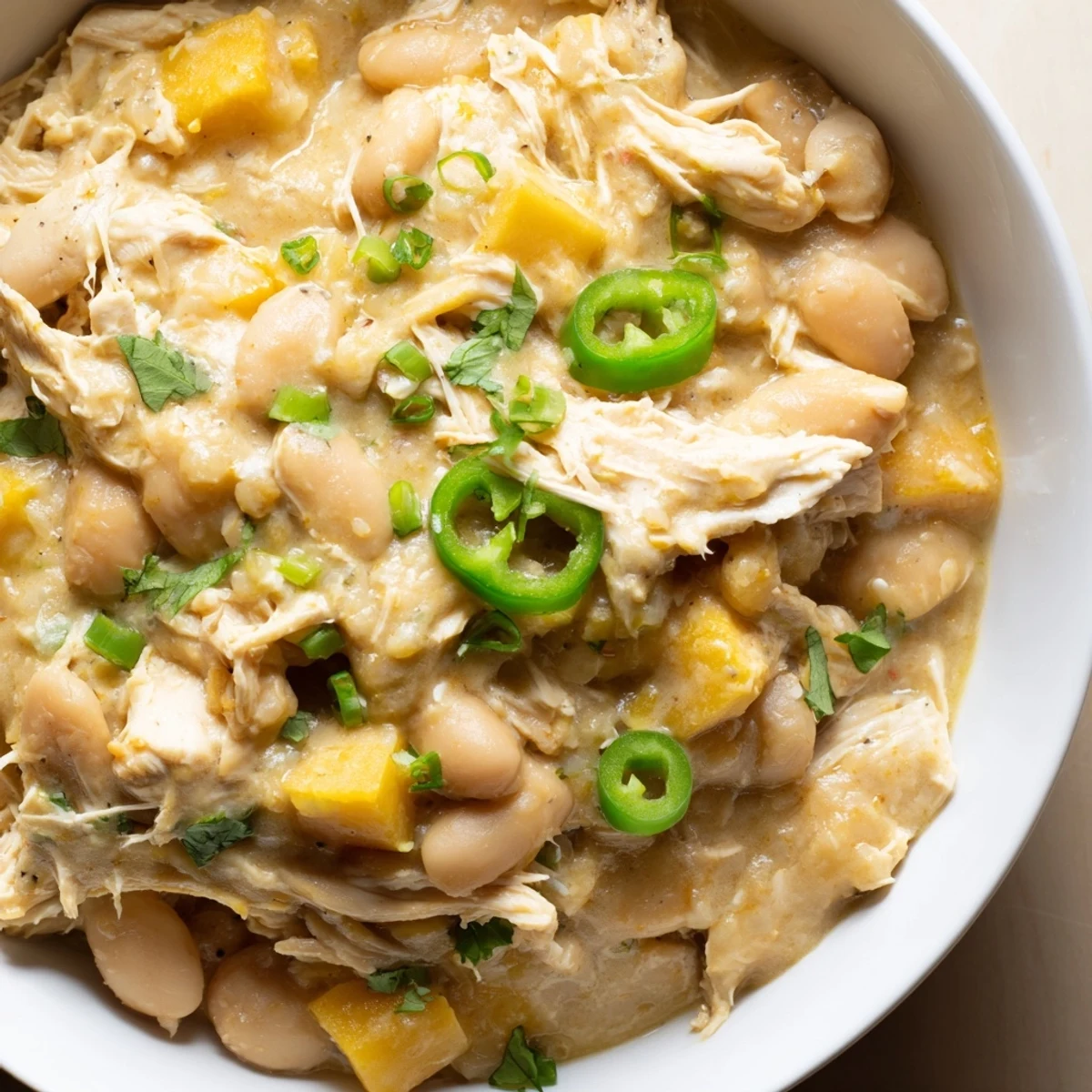 Creamy white chicken chili with beans, garnished with fresh cilantro, a flavorful Southwestern comfort meal.