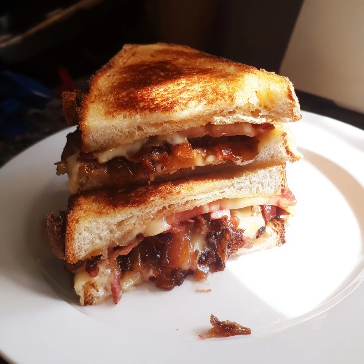 Golden brown Bacon Jam Grilled Cheese oozing with melted cheeses, ready to devour.
