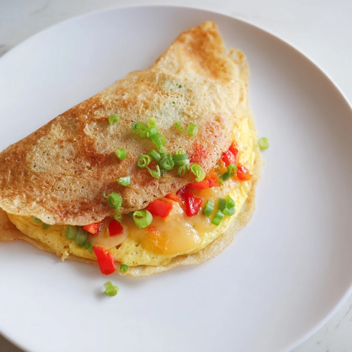 A close-up view of a crispy Rice Paper Egg Cheese Wrap, bursting with savory flavors.