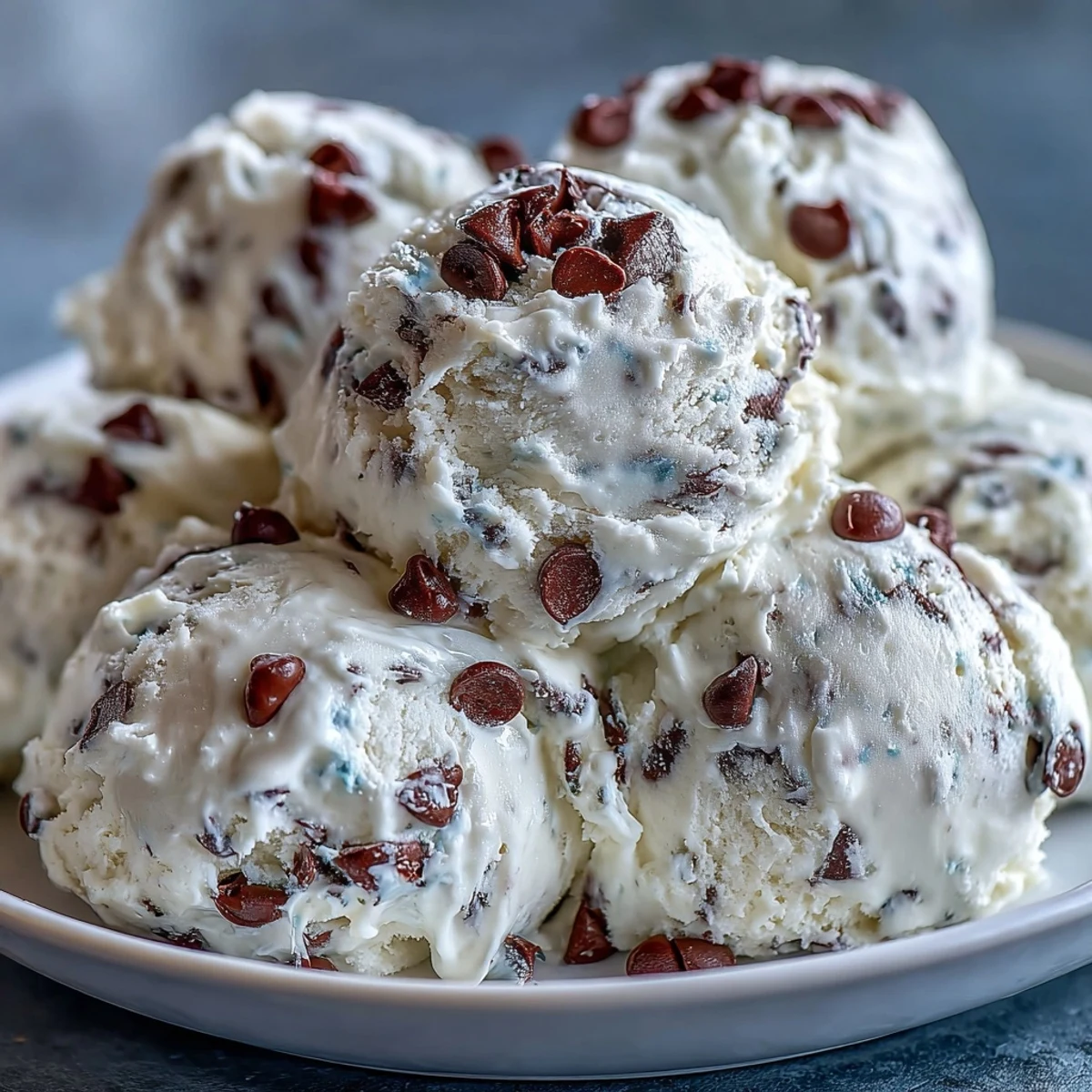 A bowl of egg-free Greek Yogurt Cookie Dough studded with mini semisweet chocolate chips, perfect for a scoopable, sweet treat.