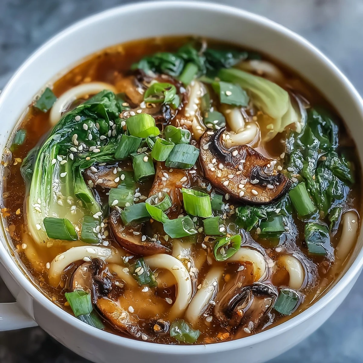 Interactive mini hot pot bowls with udon noodles, tofu, and shiitake mushrooms, served with soy sauce and chili oil for dipping.