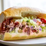 Warm, toasted hoagie roll overflowing with a flavorful Chopped Italian Grinder sandwich, a true delight.