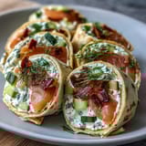 Elegant Smoked Salmon & Cucumber Cream Cheese Pinwheels—a perfect party appetizer with layers of smoked salmon, cucumber, and herbed cream cheese.