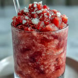 Cool off with this easy three-ingredient Frozen Strawberry Lemonade Slushie, blended smooth.