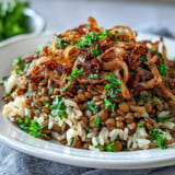 Savory Levantine Mujadara with tender lentils, rice, and a golden onion topping ready to serve.