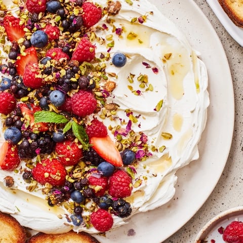 Fluffy butter board dessert featuring berries and cream cheese, perfect for sharing.  