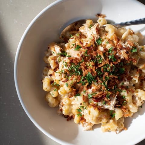 Creamy One-Pot Honey BBQ Chicken Mac and Cheese garnished with crispy onions and parsley.  