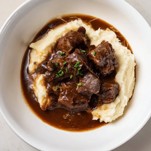 Tender beef in this hearty Fall Apple Cider Stew Mash over fluffy, cheesy mashed potatoes.