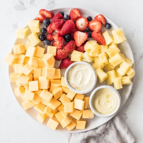 Sunshine snack tray overflowing with colorful fruits, veggies and cheese, perfect for a party snack.