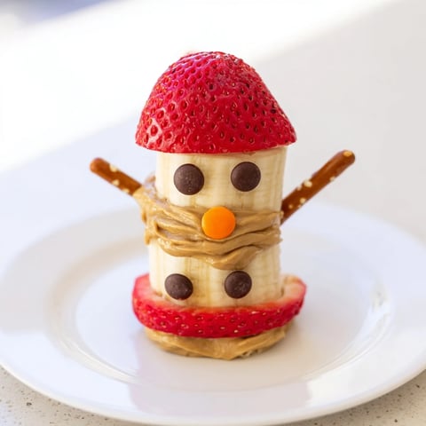 Creamy peanut butter holds banana slices together in cute Banana Peanut Butter Snowmen.