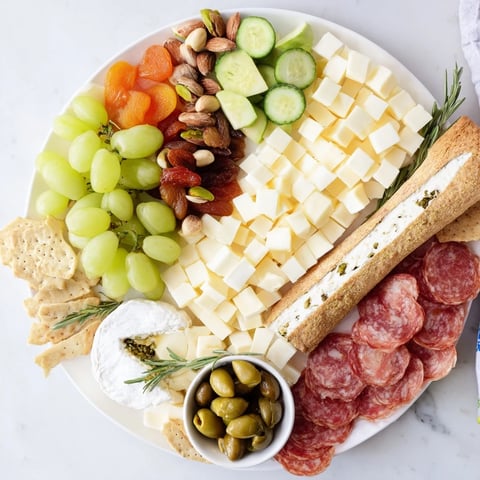 Book Club Pairing Platter showcasing delicious cheeses, meats, fruit, and snacks ready to be enjoyed.