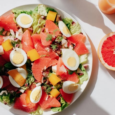 Vibrant Baby Shower Pastel Palette Salad with fresh berries and creamy blue cheese, ready to serve.