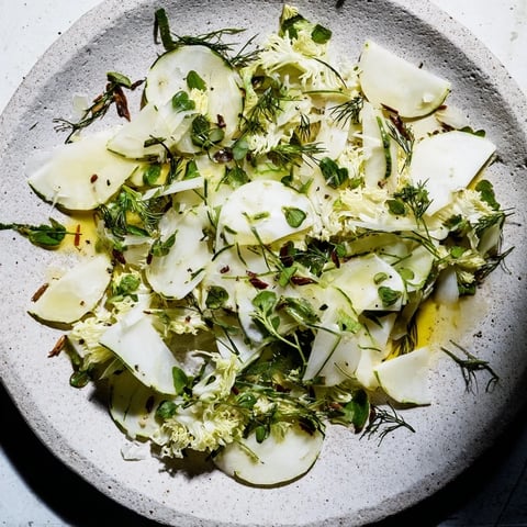 The Tundra Trek salad, a minimalist appetizer with crisp vegetables on a chilled stone serving.