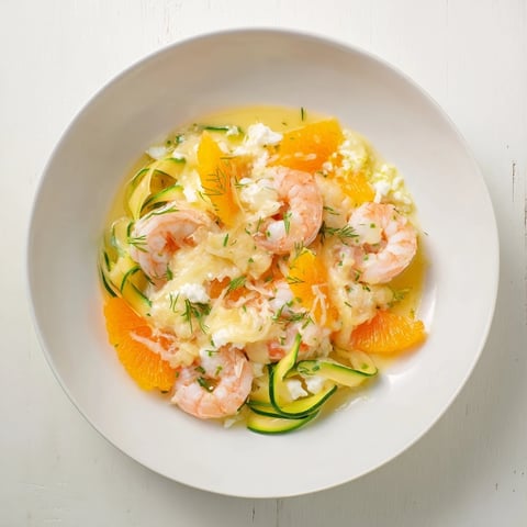 Vibrant The Coral Reef dish features perfectly cooked pink shrimp and zesty citrus with Gruyère.