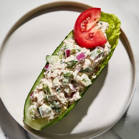 Juicy chicken salad fills a crunchy pickle sandwich, a perfect low-carb lunch.