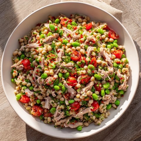 Flaky tuna and chunky chickpeas combined in a vibrant Dense Chickpea and Tuna Salad, ready to enjoy.