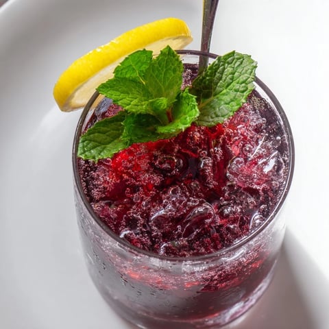 Refreshing Sleepy Girl Cherry Mocktail, garnished with mint and lemon, a soothing evening beverage.