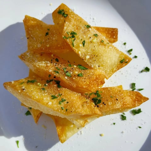 Golden, crispy garlic lumpia chips ready to serve for a delightful vegan snack or appetizer.