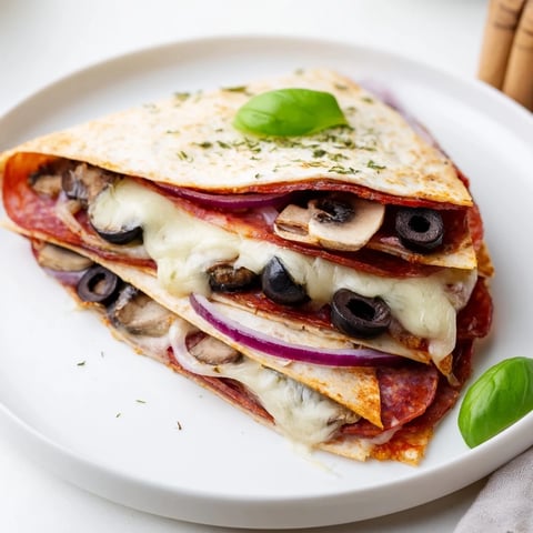 Golden brown cheesy tortilla pizza wrap with bubbling cheese and savory toppings, ready to enjoy.