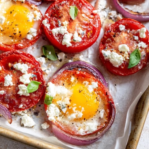 Sheet pan Tomato Feta Baked Eggs, a flavorful brunch ready with roasted tomatoes, feta and fresh basil.