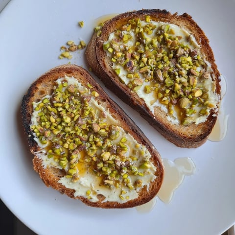Golden, toasted bread topped with rich pistachio butter, drizzled honey, and crunchy pistachios.