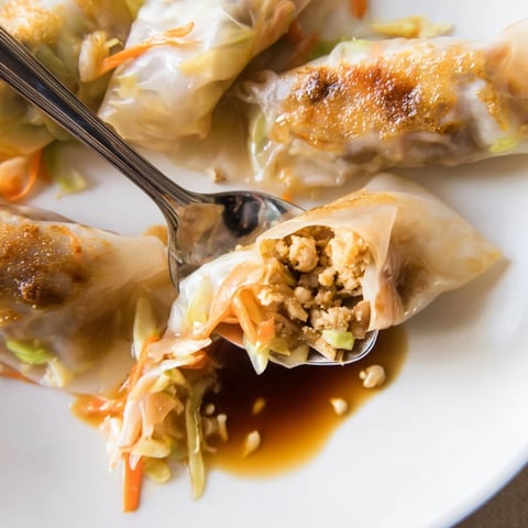 Golden-brown, crispy rice paper dumplings ready to be dipped, with visible filling and perfect texture.