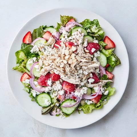 Juicy strawberries and shredded chicken rest on crisp greens, topped with a creamy poppy seed dressing in this summery Strawberry Poppy Seed Chicken Salad.  