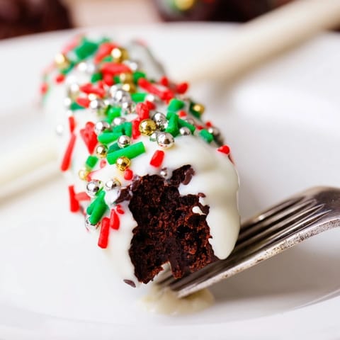 Deliciously fudgy brownie sticks dipped in white chocolate, perfect for holiday gifting.  