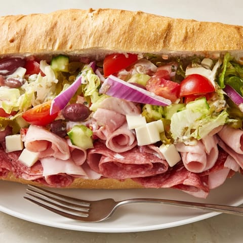 A delicious, colorful Flavor Mash-Up Sandwich filled with Italian meats and tangy toppings.  