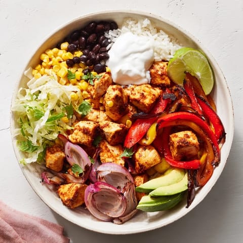 A delicious close-up of sheet pan chicken burrito bowls, ready to serve with fresh toppings.