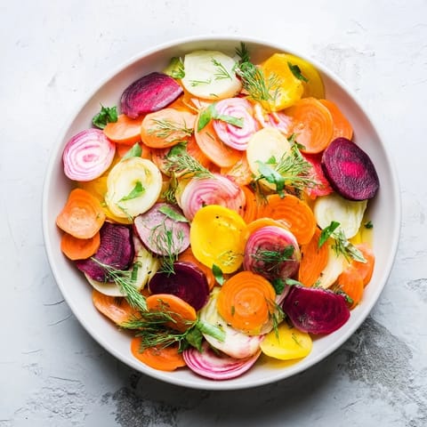Freshly assembled "Spinning Top" salad, showcasing colorful ribbons and a bright herb garnish.