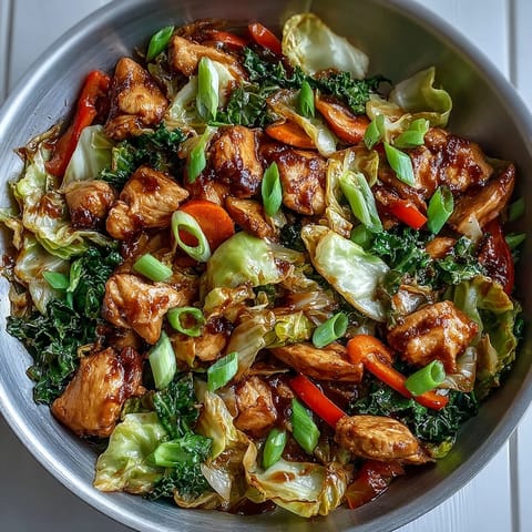 Freshly stir-fried Chicken Cabbage Stir-Fry served steaming hot alongside fluffy white jasmine rice for dinner.