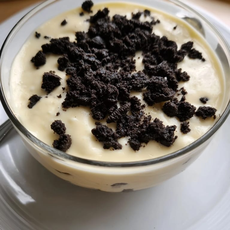 A close-up of Vanilla Pudding with Crushed Oreos, displaying layers of creamy vanilla and crunchy Oreo crumbs.