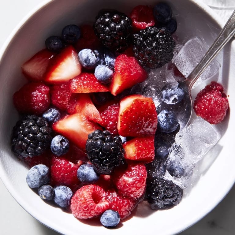 Bright red and purple berries in chilled coconut water create a vibrant Nature's Cereal Bowl, ready to eat!