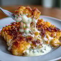 Funeral Potatoes and Ham Breakfast Skillet with golden hash browns, savory ham, and a cheesy, creamy sauce, topped with crunchy cornflakes.