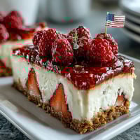 Festive no-bake cheesecake decorated with fresh berries to resemble the American flag for Fourth of July celebrations.  
