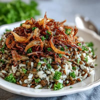 Levantine Mujadara piled high with fluffy rice and deeply caramelized, crispy onions.